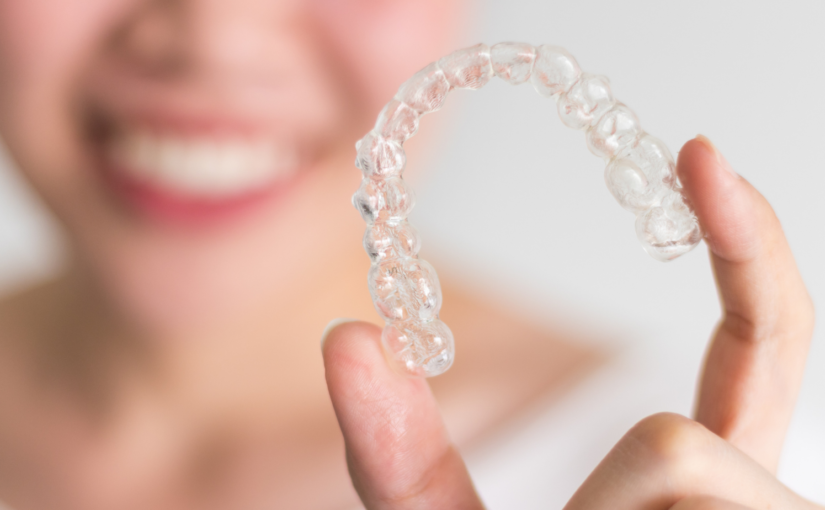 woman holding her invisalign tray